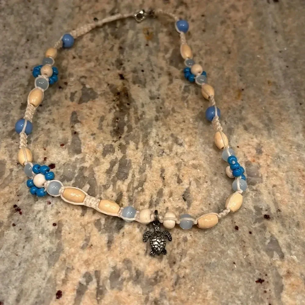 Kids beaded necklace with a silver turtle at the bottom of the necklace